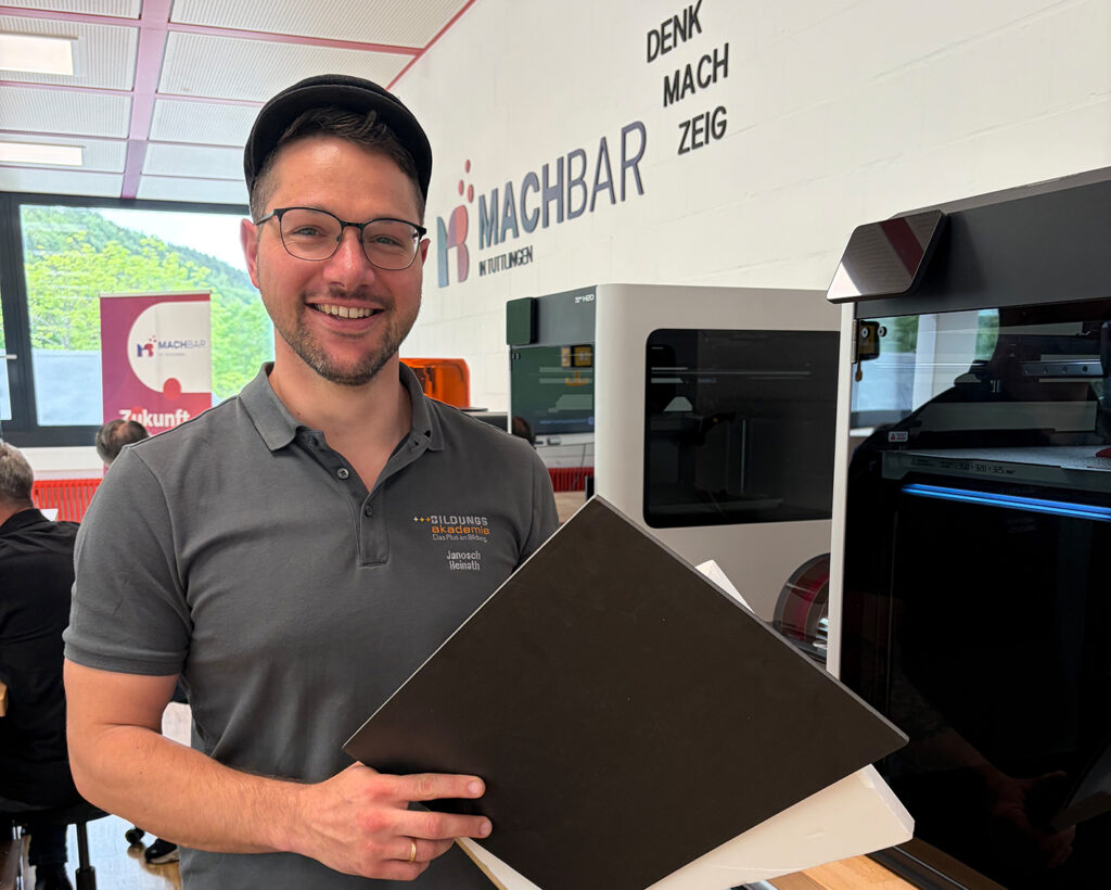 Janosch Heinath, Lehrmeister für Zimmerer an der Bildungsakademie Rottweil, hält Materialplatten im Kreativraum 'Machbar in Tuttlingen' der BBT.